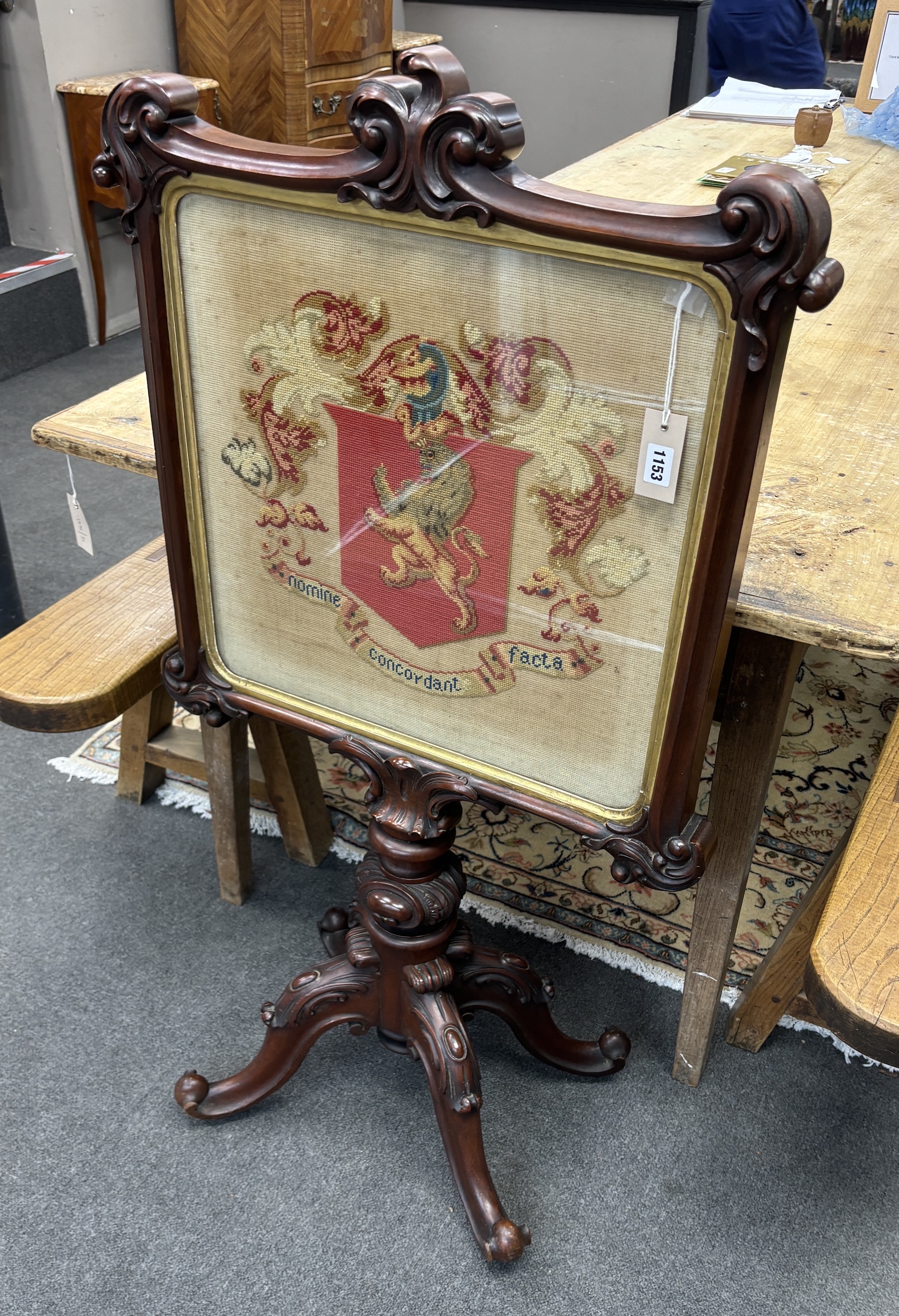 A Victorian carved mahogany firescreen, worked with armorial crest, width 64cm, height 119cm, Provenance: Same owner since early 20th century, commissioned for the Grace family